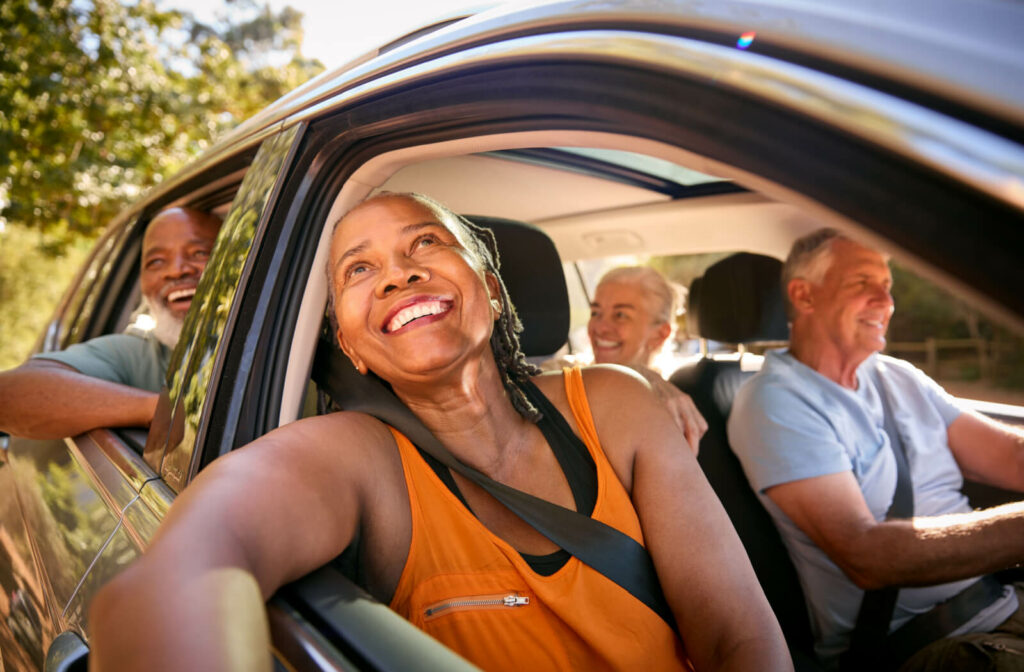 A group of older adults enjoying a road trip in a car